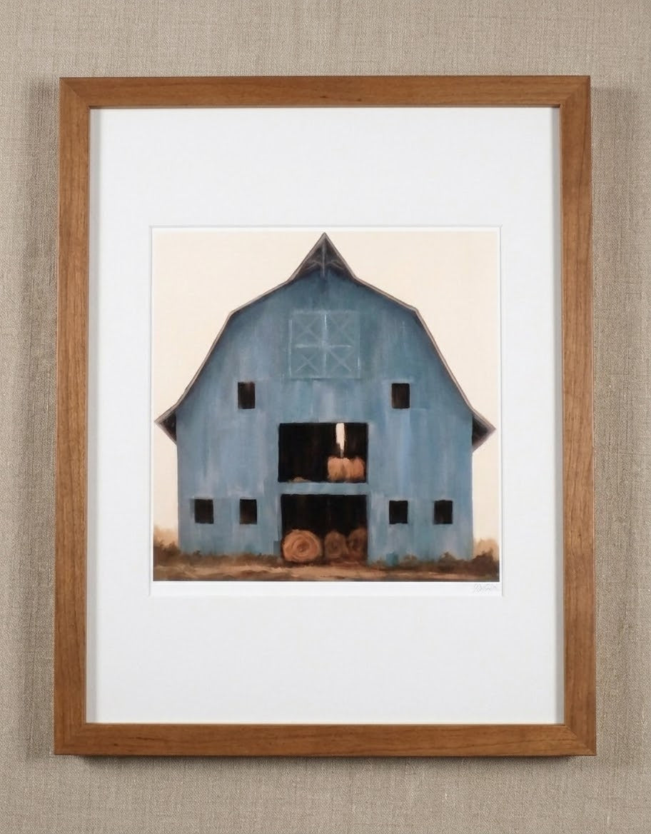Country Living blue barn with rolls of hay