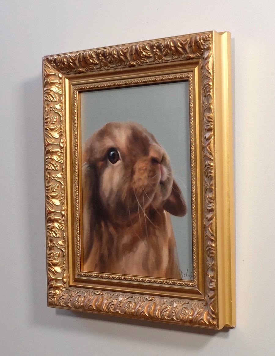Coco bunny with the blue background in ornate gold frame