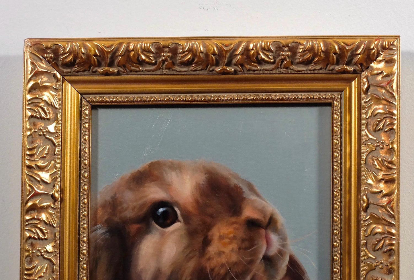 Coco bunny with the blue background in ornate gold frame