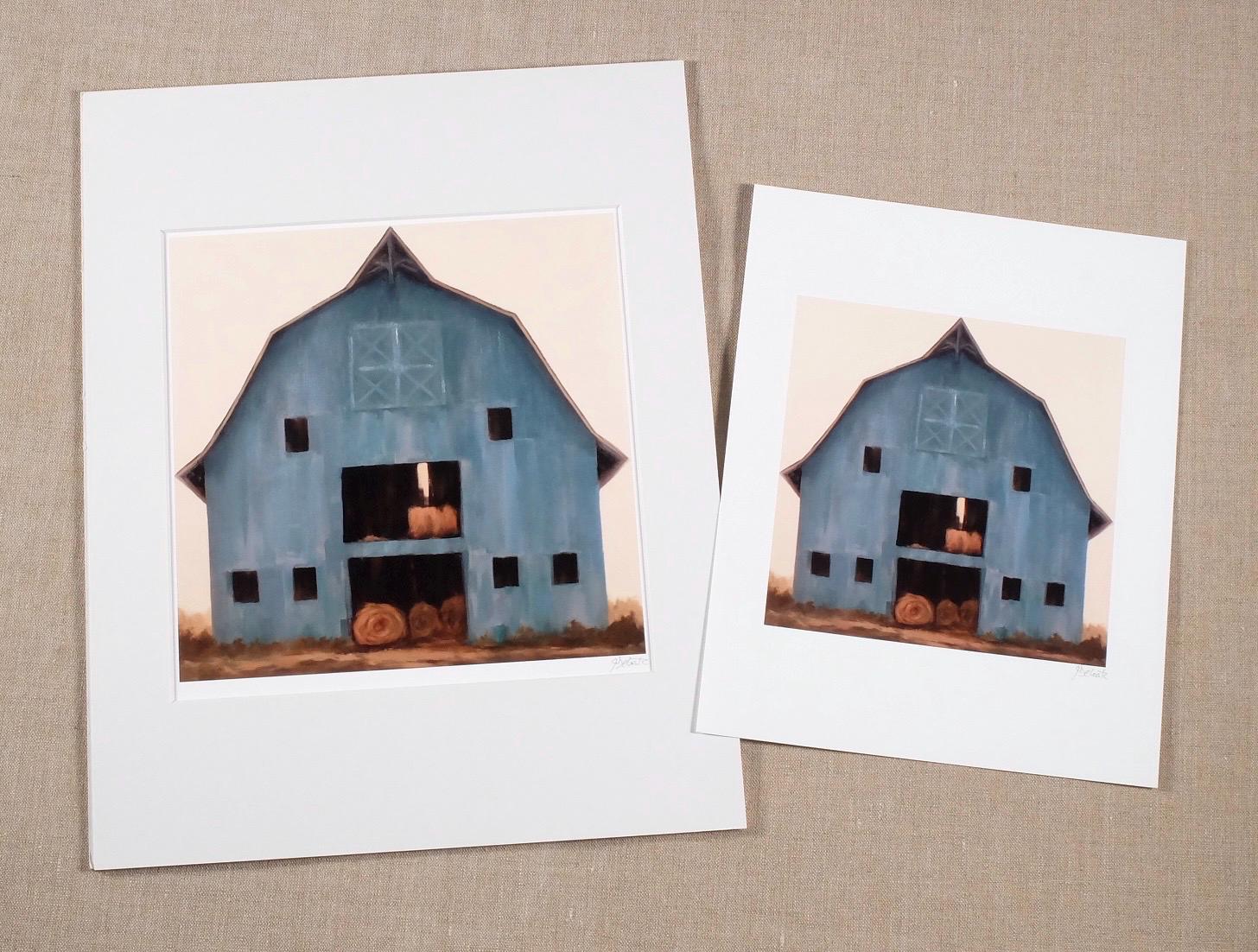 Country Living blue barn with rolls of hay
