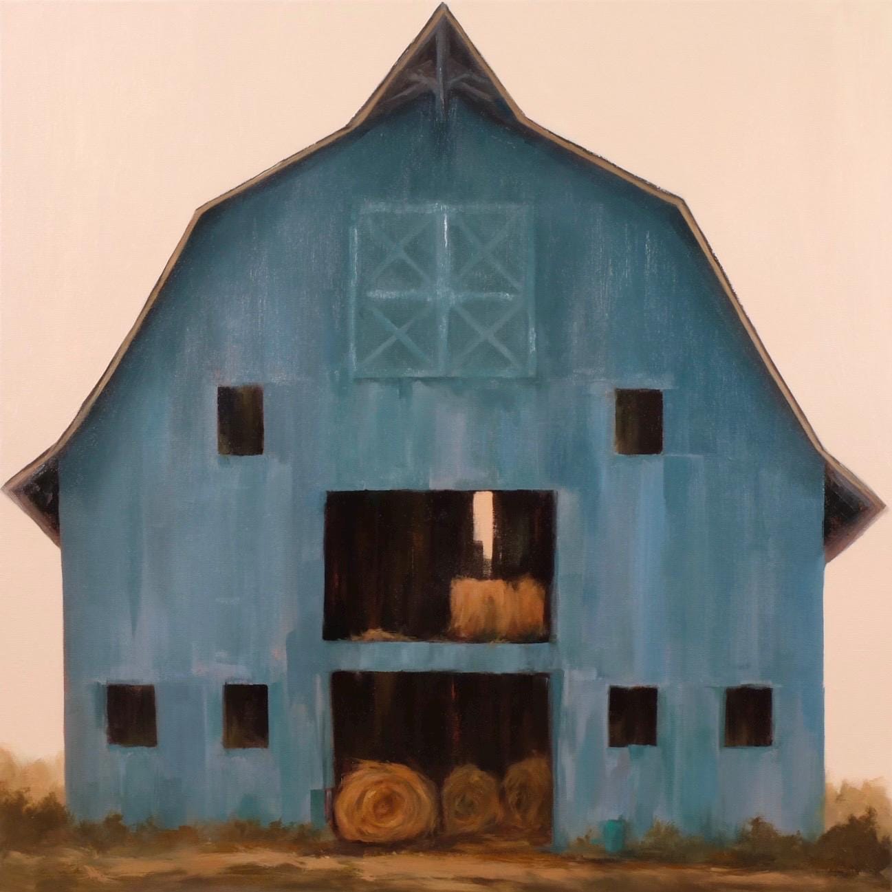 Country Living blue barn with rolls of hay